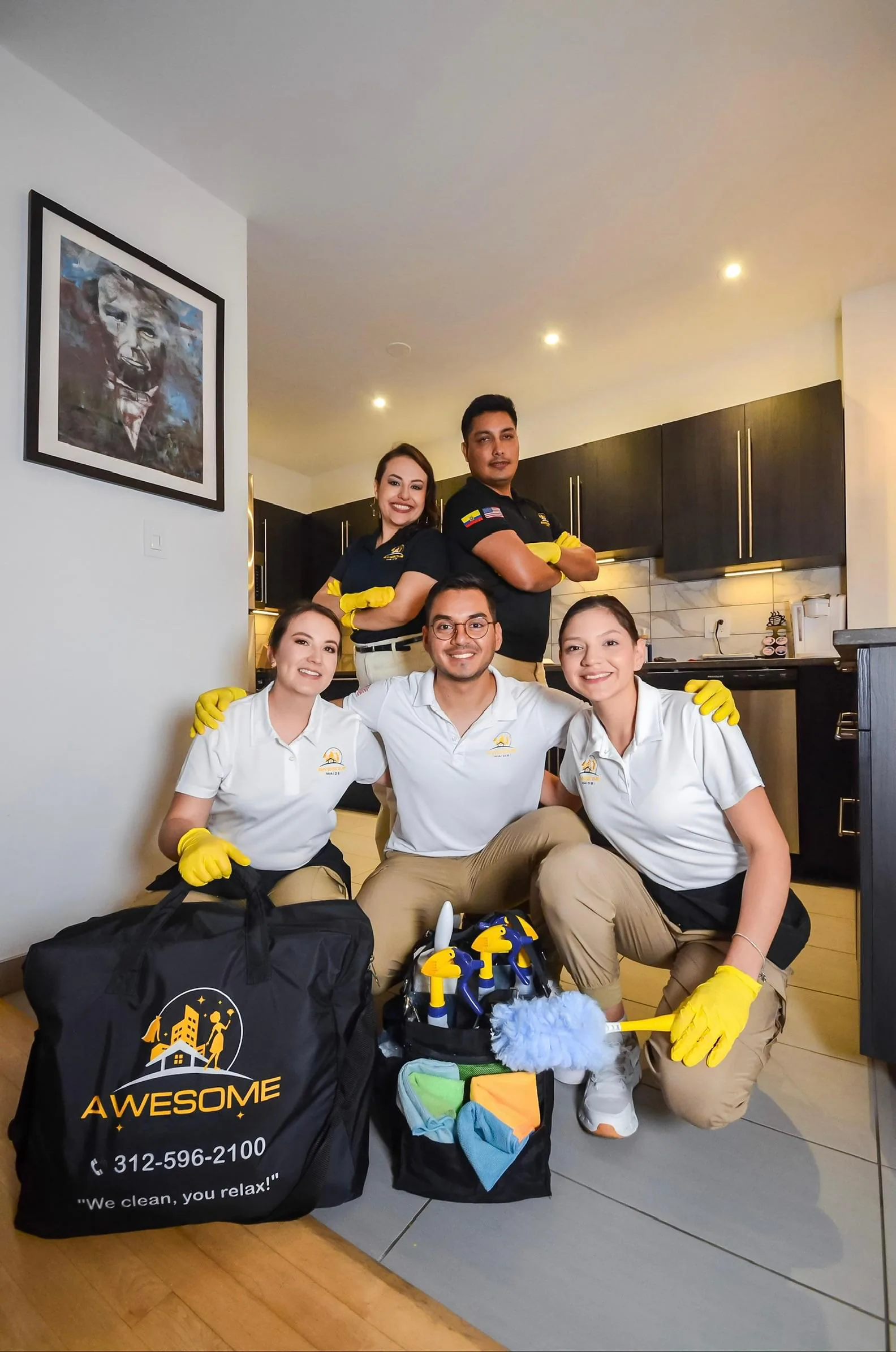 The Awesome Cleaning team — five members posed with branded supply bag